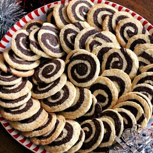 Top down view of a platter of Chocolate Pinwheel Cookies in a spiral design.