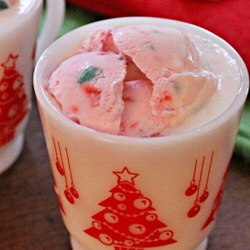 Vintage white and red punch glass filled with Peppermint Eggnog Christmas Punch.