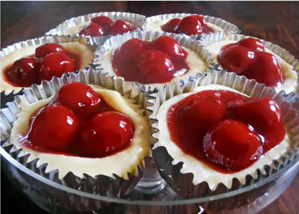 Close-up of scrumptious Cherry Cream Cheese Tarts, topped with luscious cherry pie filling, nestled on a vanilla wafer crust. A delectable and easy-to-make dessert option that's sure to impress! #CherryTarts #CreamCheeseDessert #DeliciousTreats