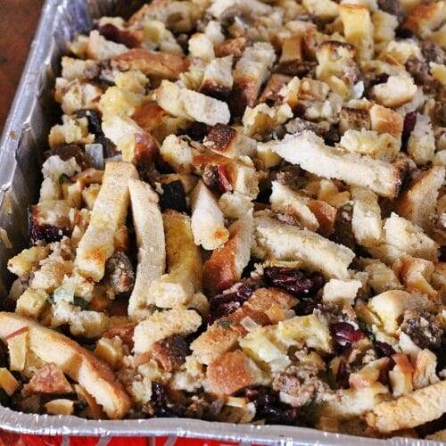 Full pan of baked sourdough stuffing, mixed with sausage, herbs, cranberries and apples
