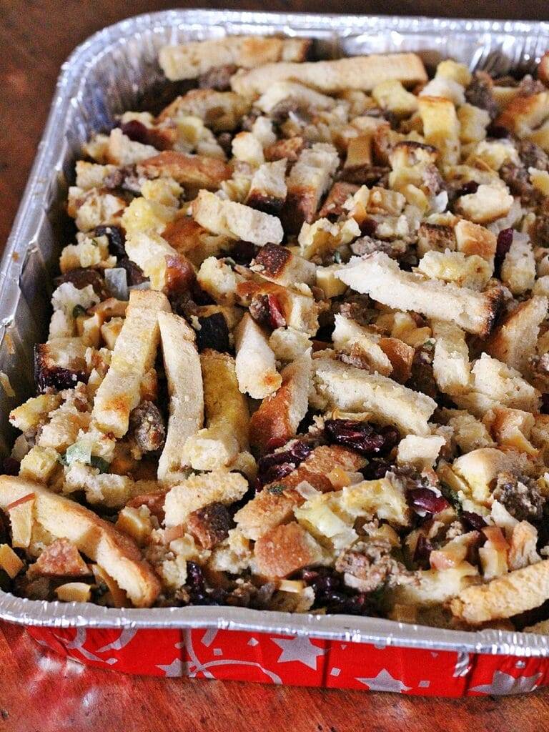 Full pan of baked sourdough stuffing, mixed with sausage, herbs, cranberries and apples