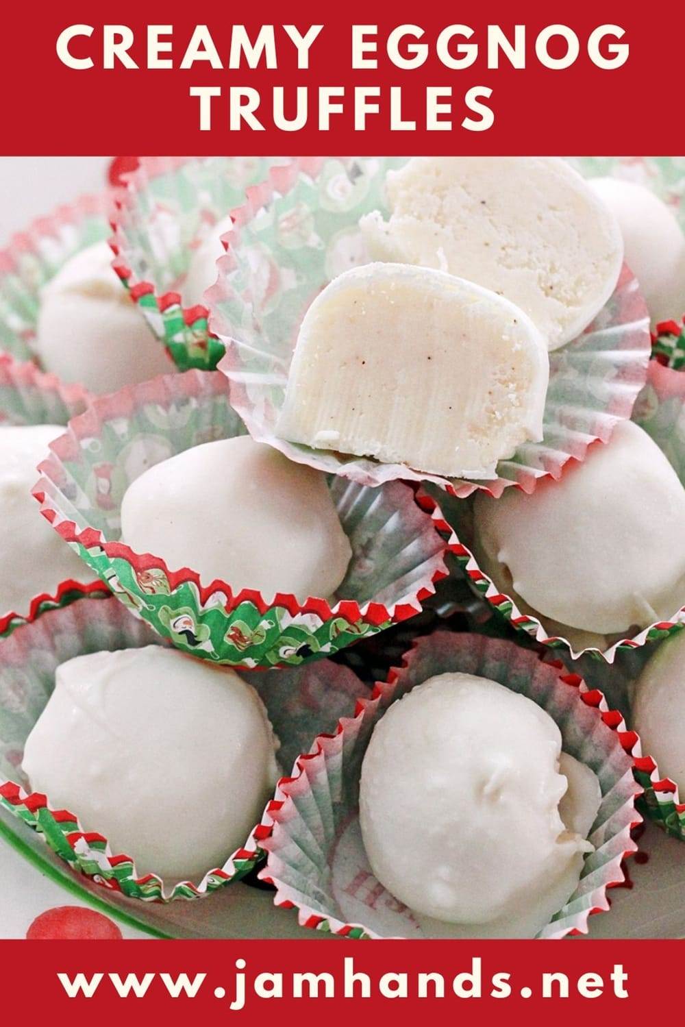 A red and white polka dot dish piled high with white eggnog truffles, each truffle in a red and green holiday candy liner.